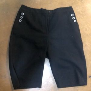 Black Bermuda shorts with white buttons